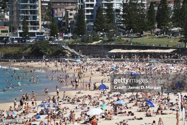 Sunbakers gather on Coogee Beach on September 12, 2021 in Sydney, Australia. COVID-19 restrictions are set to ease on Monday for people in NSW who...