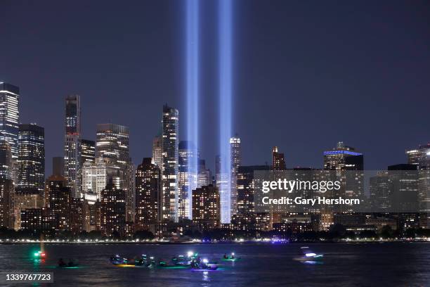 People kayak in the Hudson River in front of the Tribute in Light, lower Manhattan and One World Trade Center in New York City on the 20th...