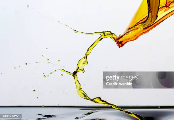 golden oil drops, splashing water - pureza imagens e fotografias de stock
