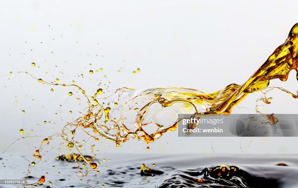Golden oil drops, splashing water