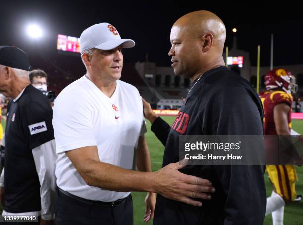 David Shaw of the Stanford Cardinal and Clay Helton of the USC Trojans shake hands at the end of the game after a 42-28 Cardinal win at Los Angeles...