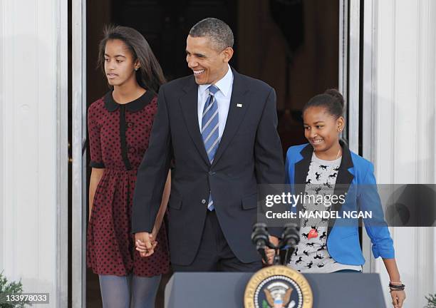 President Barack Obama and his daughters Sasha and Malia arrive for the pardoning ceremony for the National Thanksgiving Turkey at the North Portico...