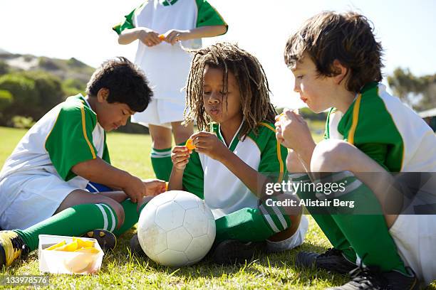 boys resting during half time of a football match - only boys stock pictures, royalty-free photos & images