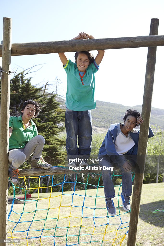 Group of teenage boys on climbing frame