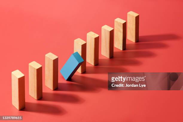 blue block domino  standing out from the crowd - dominoes stock pictures, royalty-free photos & images
