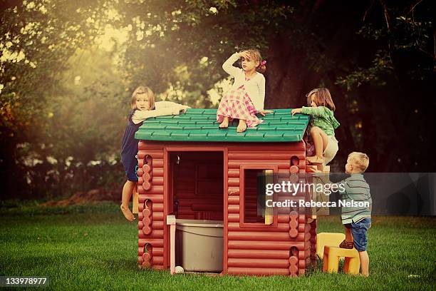 little kids climbing on play house - playhouse stockfoto's en -beelden