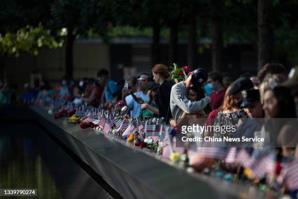 People mourn victims at the National 9/11 Memorial and Museum to commemorate the 20th anniversary of the September 11th terrorist attacks on...