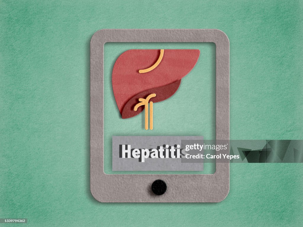 Conceptual image of hepatitis disease with digital table made of craft paper
