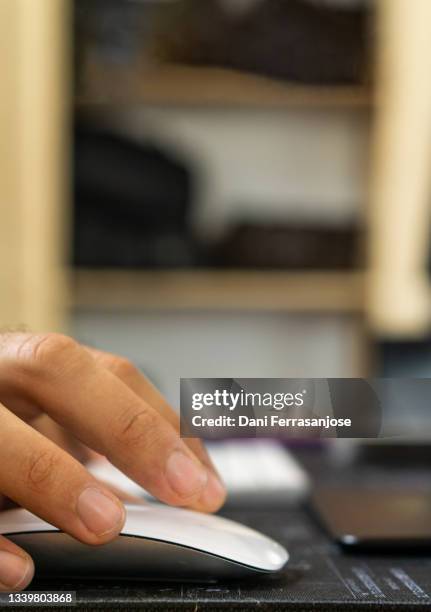 close-up shot of handheld using computer mouse while working from home - computer mouse close up stock pictures, royalty-free photos & images