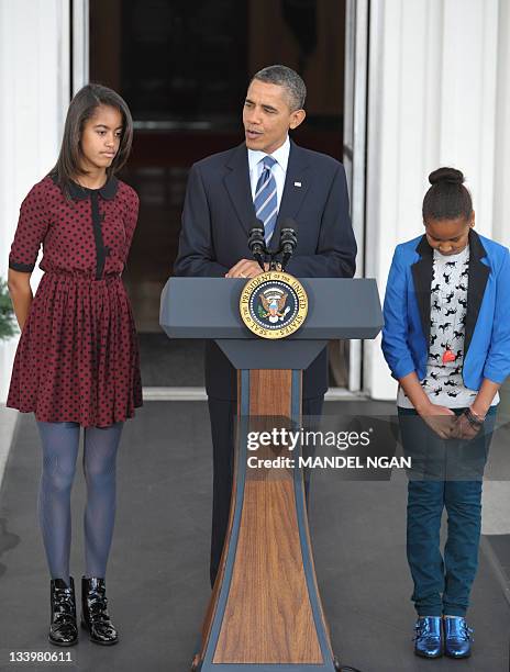 President Barack Obama and his daughters Sasha and Malia speak before the pardoning ceremony for the National Thanksgiving Turkey at the North...