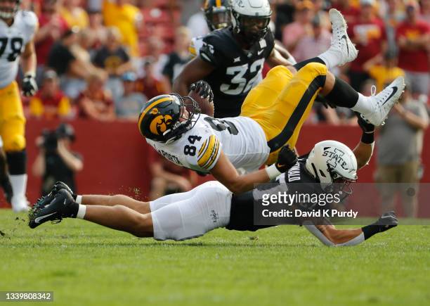 Tight end Sam LaPorta of the Iowa Hawkeyes is tackles by defensive back Craig McDonald of the Iowa State Cyclones as he rushed for yards in the first...