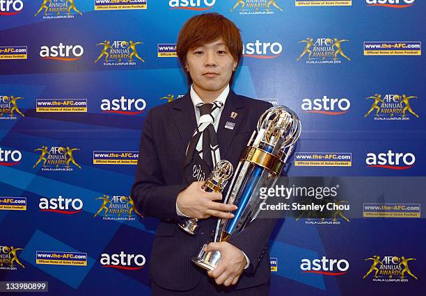 Aya Miyama of Japan poses with the 2011 AFC Women's Player of the Year Award during the 2011 AFC Annual Awards at Mandarin Oriental Hotel on November...