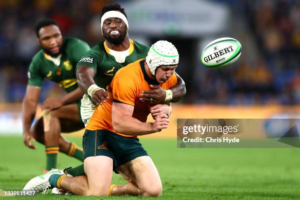 Siya Kolisi of South Africa tackles Michael Hooper of the Wallabies during the Rugby Championship match between the South Africa Springboks and the...