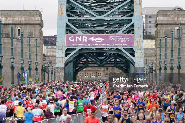 Runners cross the Tyne Bridge in Newcastle during the 40th Great North Run on September 12, 2021 in Newcastle upon Tyne, England. Approximately...