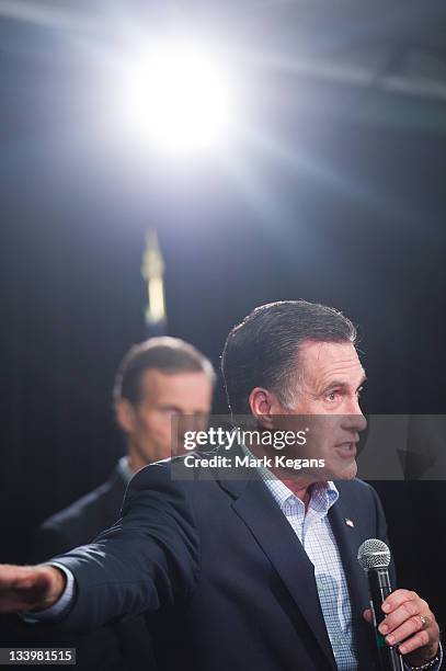 Republican presidential candidate former Massachusetts Gov. Mitt Romney speaks as U.S. Sen. John Thune stands by during an appearance before...