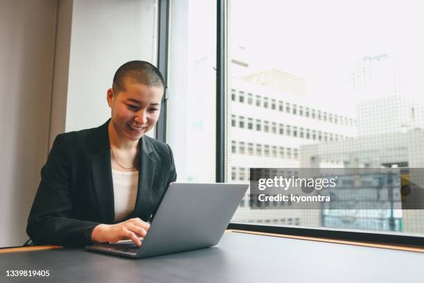 portrait of a non-binary gender business person in asia - shaved head stock pictures, royalty-free photos & images