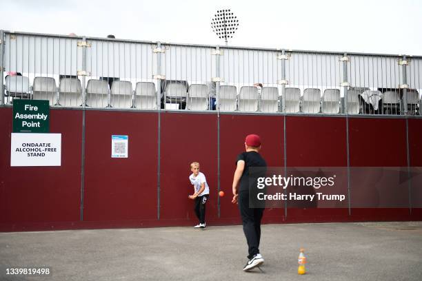 Young supporter plays a shot with a fanta bottle during the lunch break during Day One of the LV= Insurance County Championship match between...