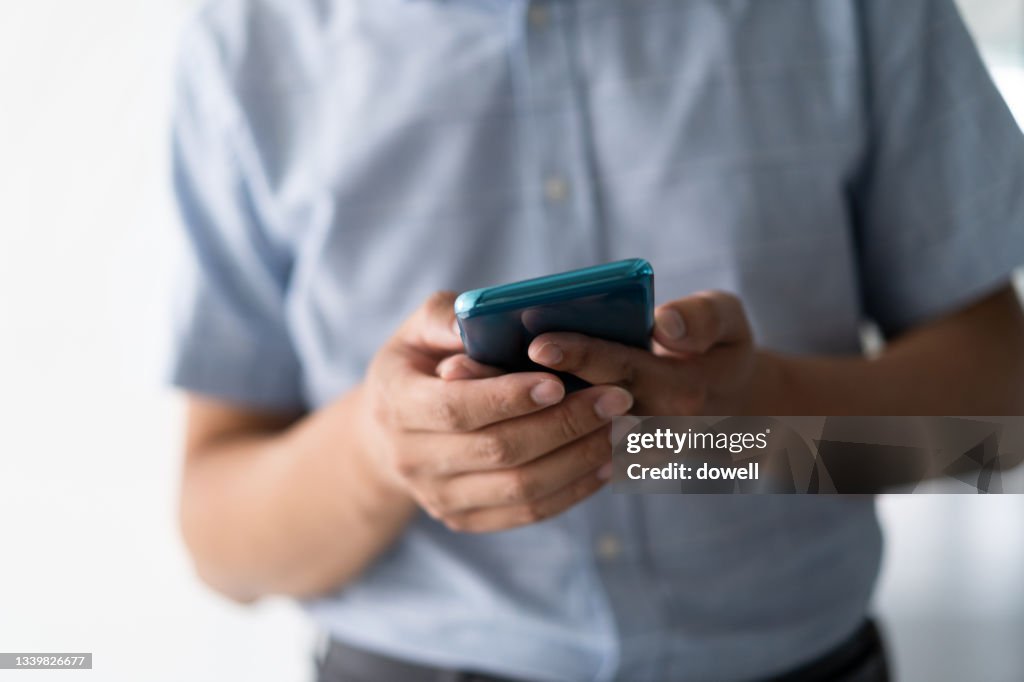 Businessman using smart phone in office