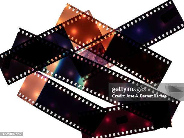 color negative 35mm film stripes on a white background. - film negitive stock pictures, royalty-free photos & images