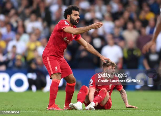 Harvey Elliott of Liverpool reacts as he looks to be injured as Mohamed Salah of Liverpool calls for medical attention during the Premier League...