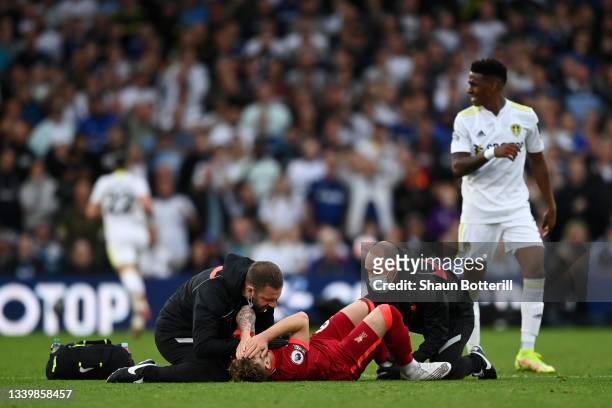 Harvey Elliott of Liverpool receives medical treatment during the Premier League match between Leeds United and Liverpool at Elland Road on September...