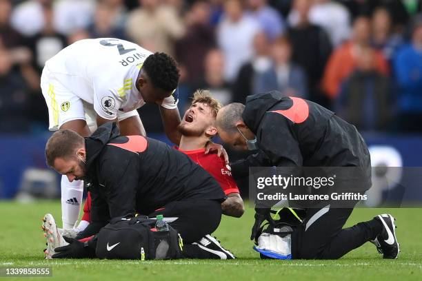 Harvey Elliott of Liverpool receives medical treatment during the Premier League match between Leeds United and Liverpool at Elland Road on September...