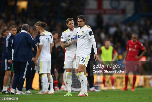 Pascal Struijk of Leeds United is consoled by Liam Cooper of Leeds United after being shown a red card for a challenge on Harvey Elliott of Liverpool...