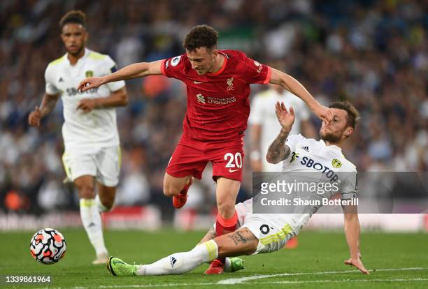 Diogo Jota of Liverpool is challenged by Liam Cooper of Leeds United during the Premier League match between Leeds United and Liverpool at Elland...