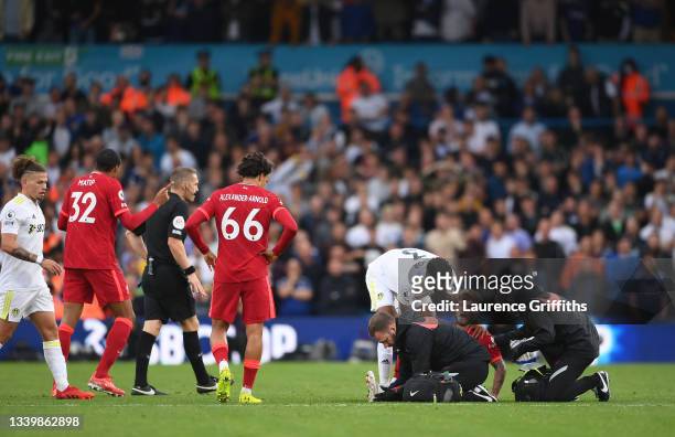 Harvey Elliott of Liverpool receives medical treatment during the Premier League match between Leeds United and Liverpool at Elland Road on September...