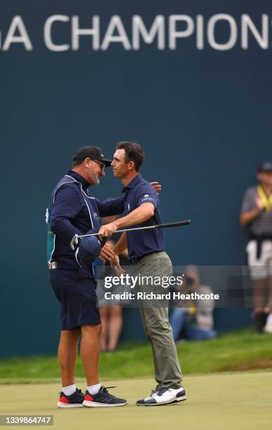 Billy Horschel of the United States of America hugs caddie Mark ‘Fooch’ Fulcher after finishing their round on the 18th green during Day Four of The...