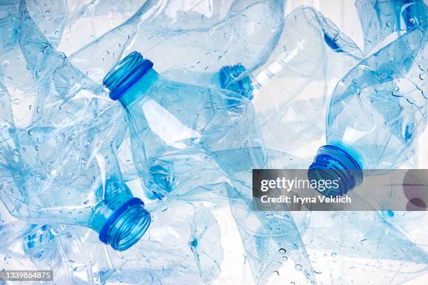 group of crumpled plastic drink water bottles for recycling. - plastic bottles stock pictures, royalty-free photos & images