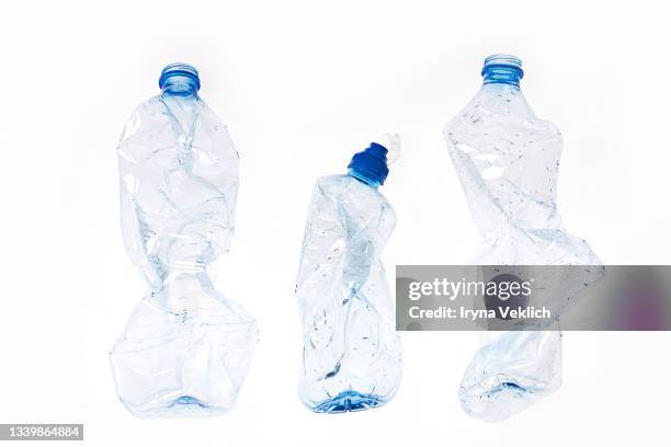 group of crumpled plastic drink water bottles for recycling. - white trash stock-fotos und bilder