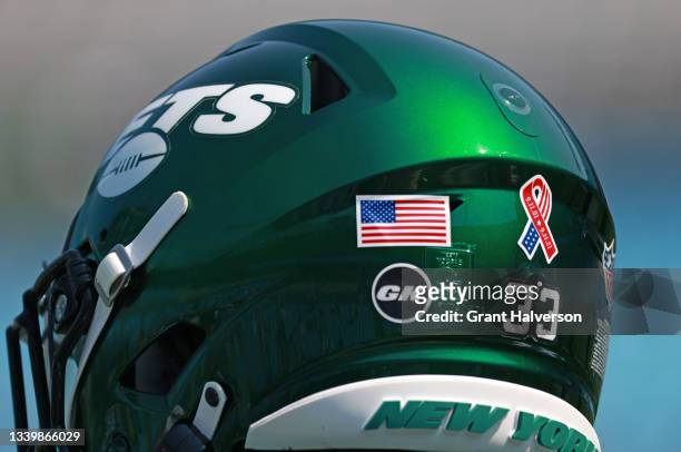 Special logo honoring the September 11th victems is seen on the back of the New York Jets helmets during their game against the Carolina Panthers at...