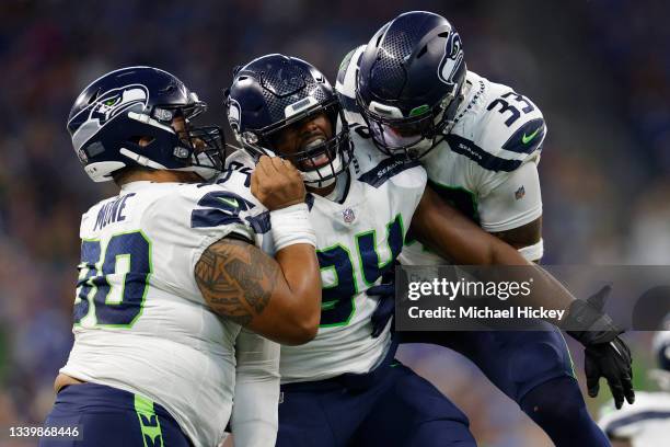 Rasheem Green of the Seattle Seahawks celebrates with Bryan Mone and Jamal Adams after a sack against the Indianapolis Colts during the first quarter...