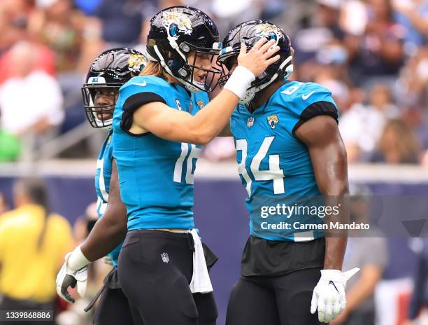 Trevor Lawrence of the Jacksonville Jaguars celebrates a 22-yard touchdown pass with Chris Manhertz against the Houston Texans during the second...