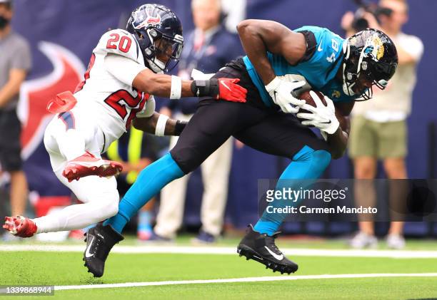 Justin Reid of the Houston Texans attempts to tackle Chris Manhertz of the Jacksonville Jaguars during the first half at NRG Stadium on September 12,...