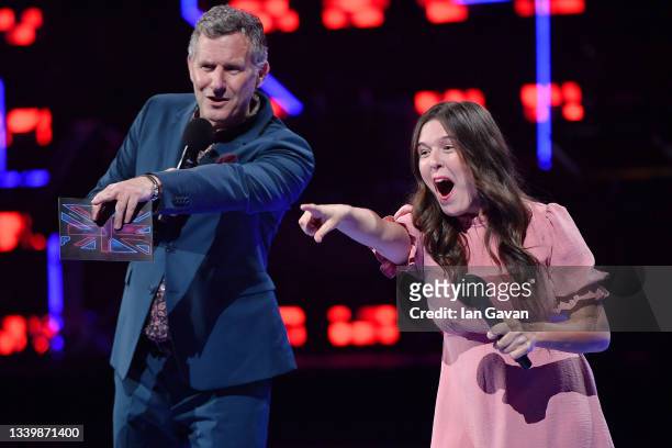 Host Adam Hills performs on stage with Rosie Jones at the National Lottery's ParalympicsGB Homecoming at SSE Arena Wembley on September 12, 2021 in...