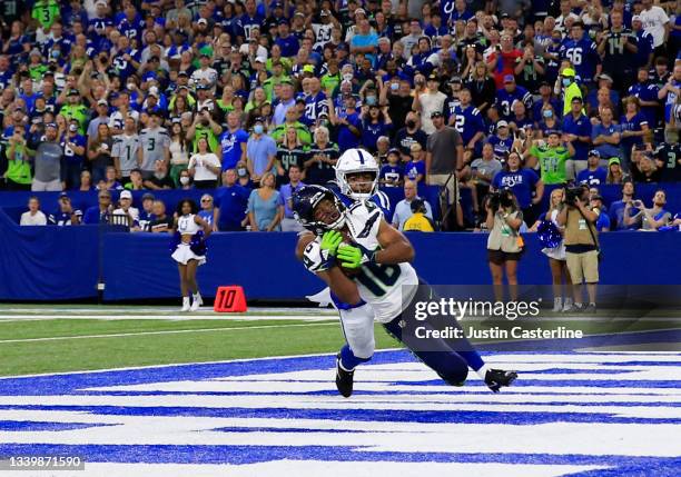 Tyler Lockett of the Seattle Seahawks catches a 23-yard touchdown pass from Russell Wilson during the first quarter against the Indianapolis Colts at...