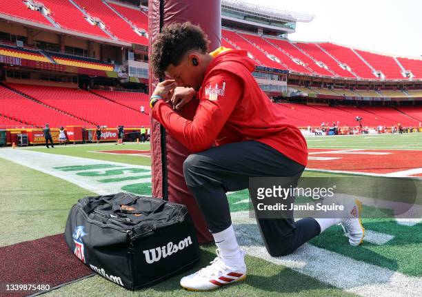 Quarterback Patrick Mahomes of the Kansas City Chiefs prays prior to warming up for the game against the Cleveland Browns at Arrowhead Stadium on...