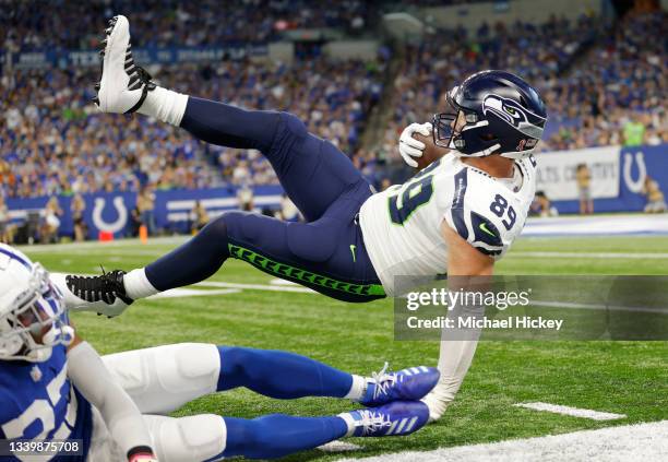 Seattle Seahawks tight end Will Dissly is tackled on the sideline during the first half against the Indianapolis Colts at Lucas Oil Stadium on...