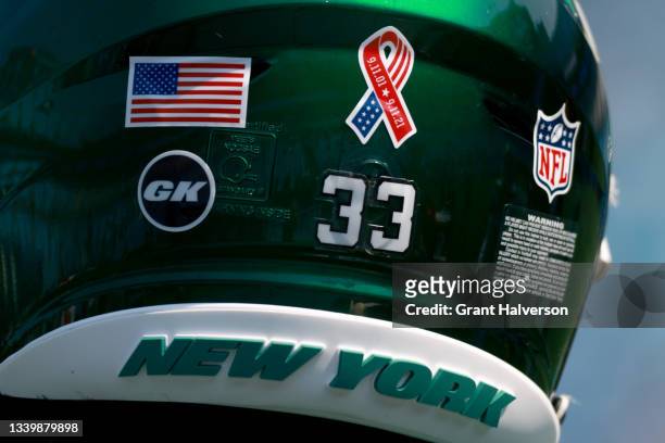 Special logo honoring the September 11th victems is seen on the back of the New York Jets helmets during their game against the Carolina Panthers at...