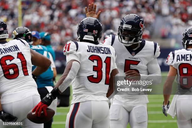 Tyrod Taylor of the Houston Texans celebrates with David Johnson after his touchdown against the Jacksonville Jaguars during the first quarter at NRG...