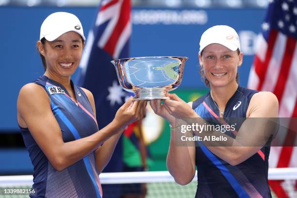 Shuai Zhang of China and Samantha Stosur of Australia celebrate with the championship trophy after defeating Coco Gauff of the United States and...