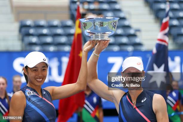 Shuai Zhang of China and Samantha Stosur of Australia celebrate with the championship trophy after defeating Coco Gauff of the United States and...