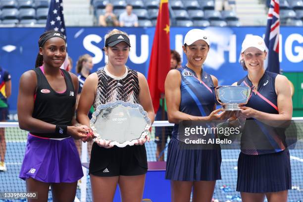 Coco Gauff of the United States and Catherine McNally of the United States smile with the runner-up trophy alongside Shuai Zhang of China and...