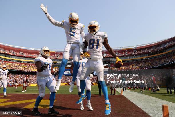 Mike Williams of the Los Angeles Chargers celebrates with teammates after catching a three yard touchdown reception during the fourth quarter against...