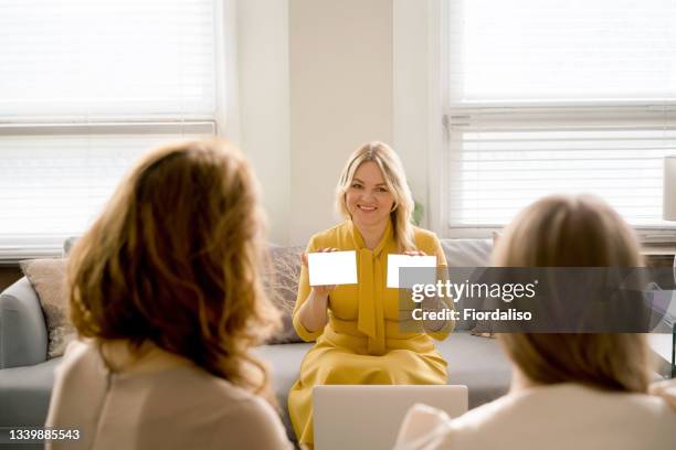 three business women talking in the office - forced marriage stockfoto's en -beelden