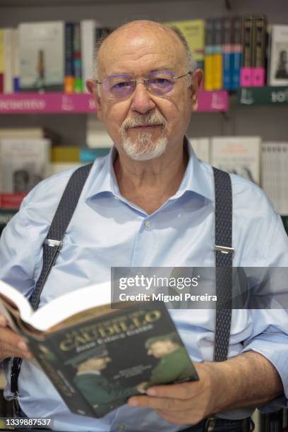 Spanish writer Juan Eslava Galán poses during the signing of his latest book, "La tentación del caudillo", at the Madrid Book Fair on September 12,...