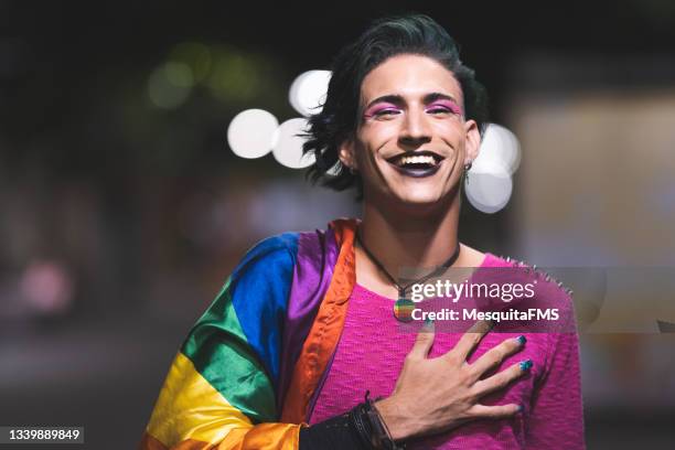 lgbt pride, gay man with hand on chest - travesti imagens e fotografias de stock