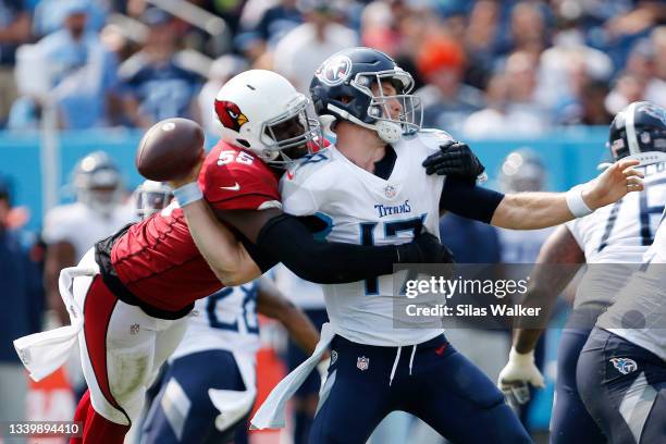 Ryan Tannehill of the Tennessee Titans fumbles after being hit by Chandler Jones of the Arizona Cardinals during the third quarter at Nissan Stadium...